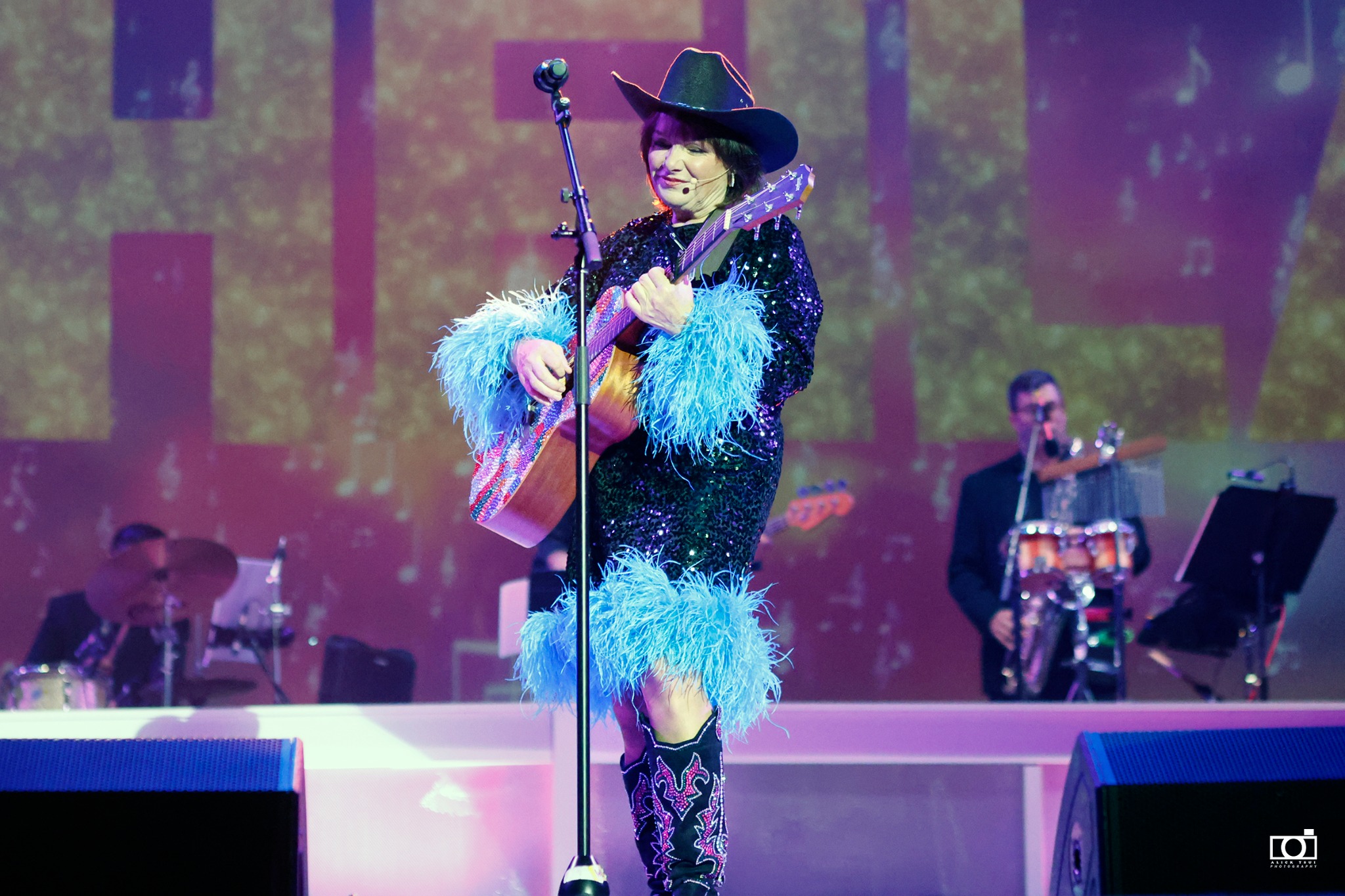 Sheila performing country music on stage