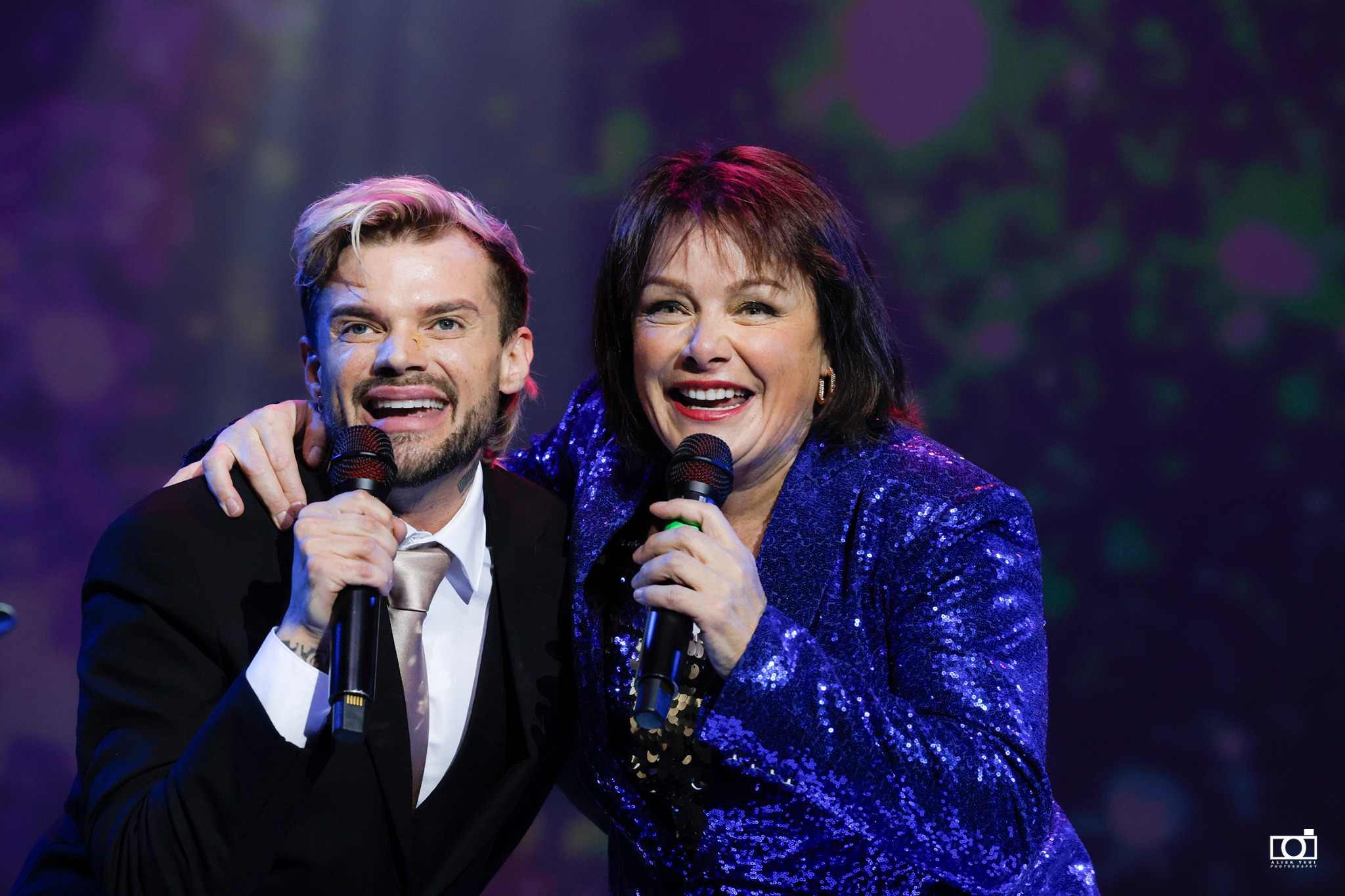 Sheila smiling with a guest performer